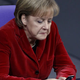 German Chancellor Angela Merkel texts on her ‘handy.’